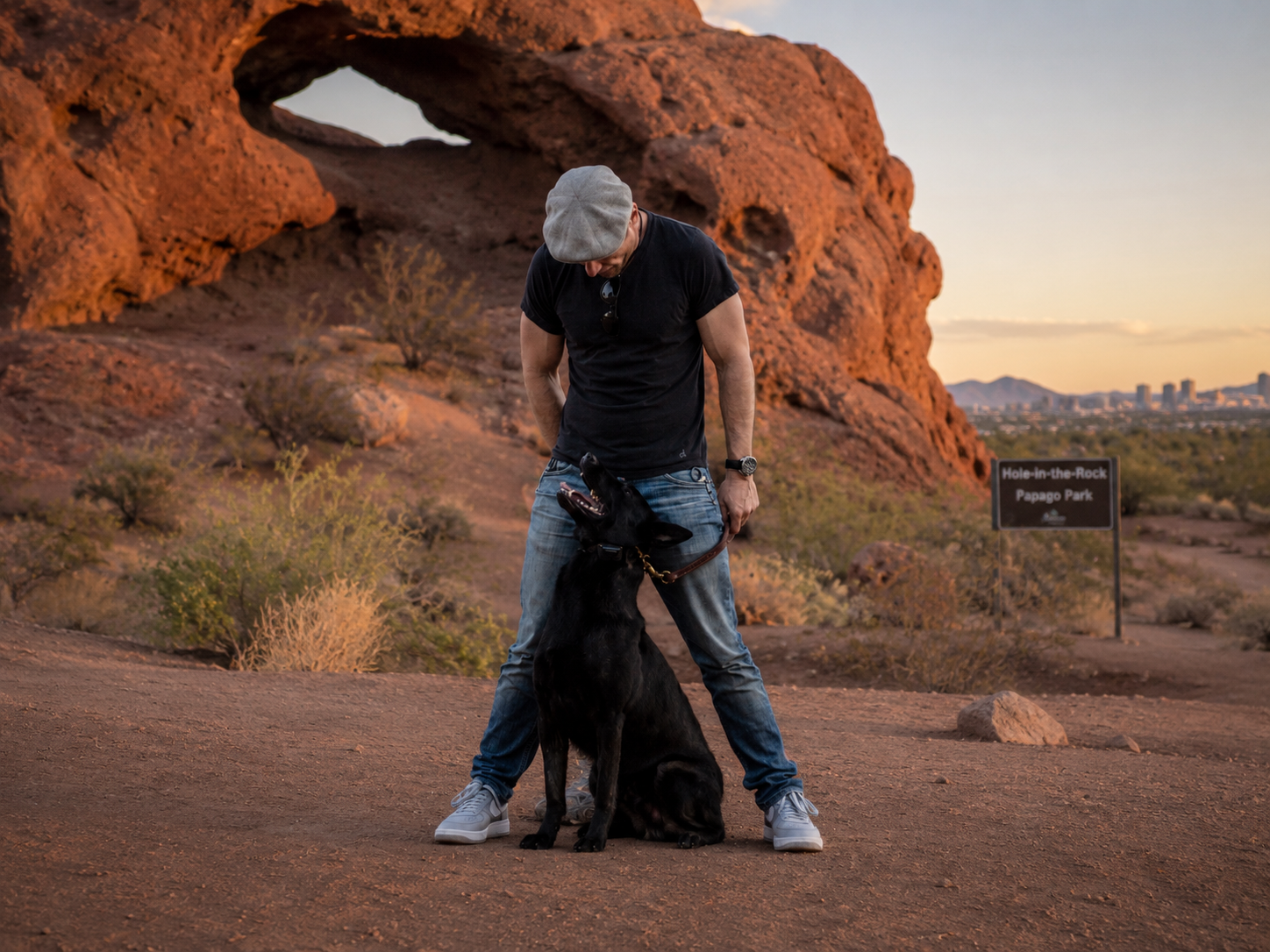 Arizona dog trainer with his black shepherd at Hole-in-the-Rock, Papago Park, Phoenix
